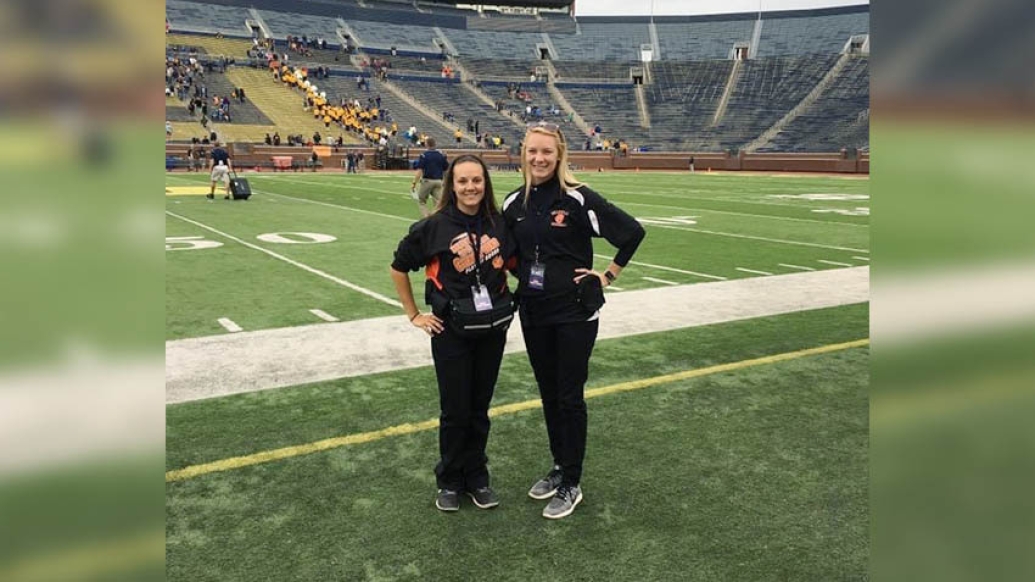 two females on the field at michigan big house