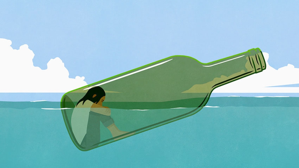 Woman floating in wine bottle in ocean
