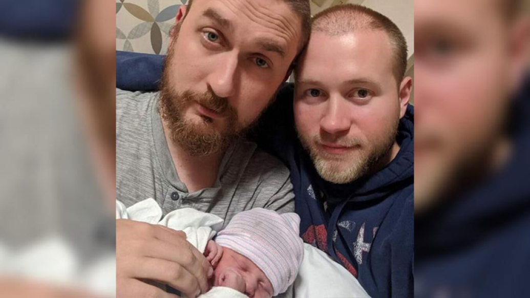 Parents holding new baby